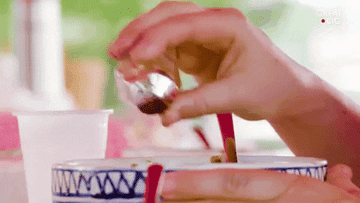 Shaking black pepper onto food