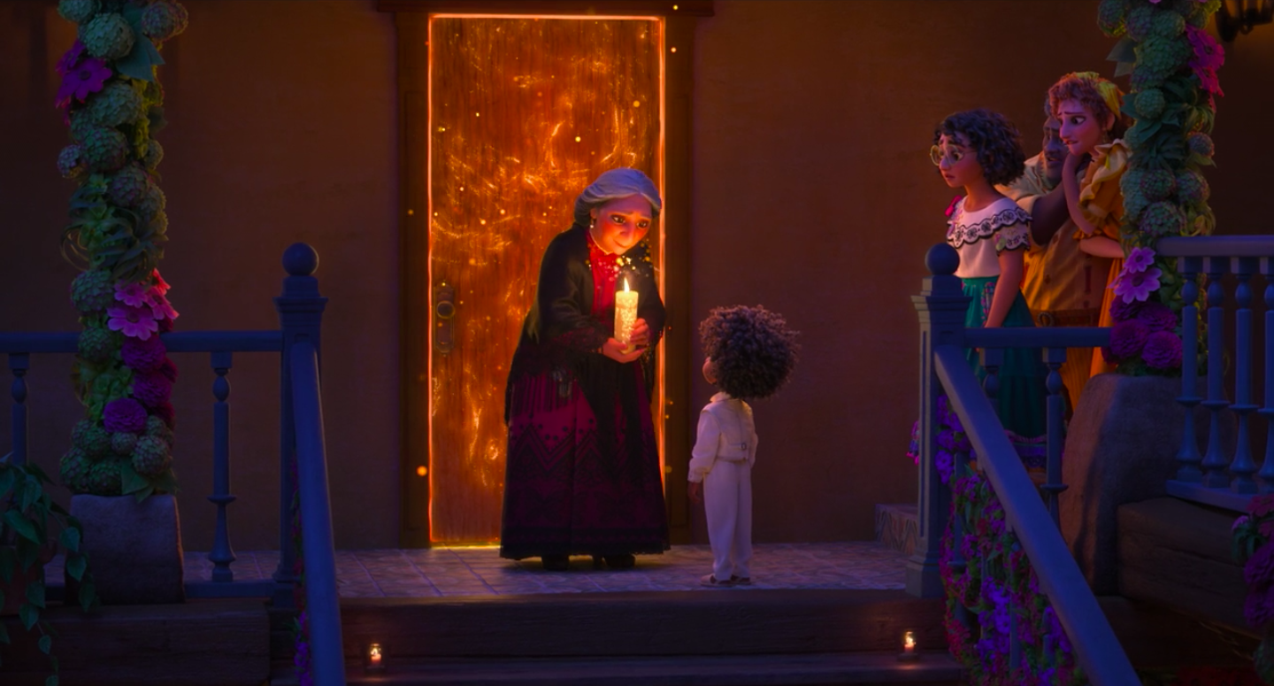 Abuela Alma holding the magical candle in front of Antonio so he can receive his gift
