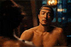 gif of Lan Mandragoran taking a bath with a woman stating the water