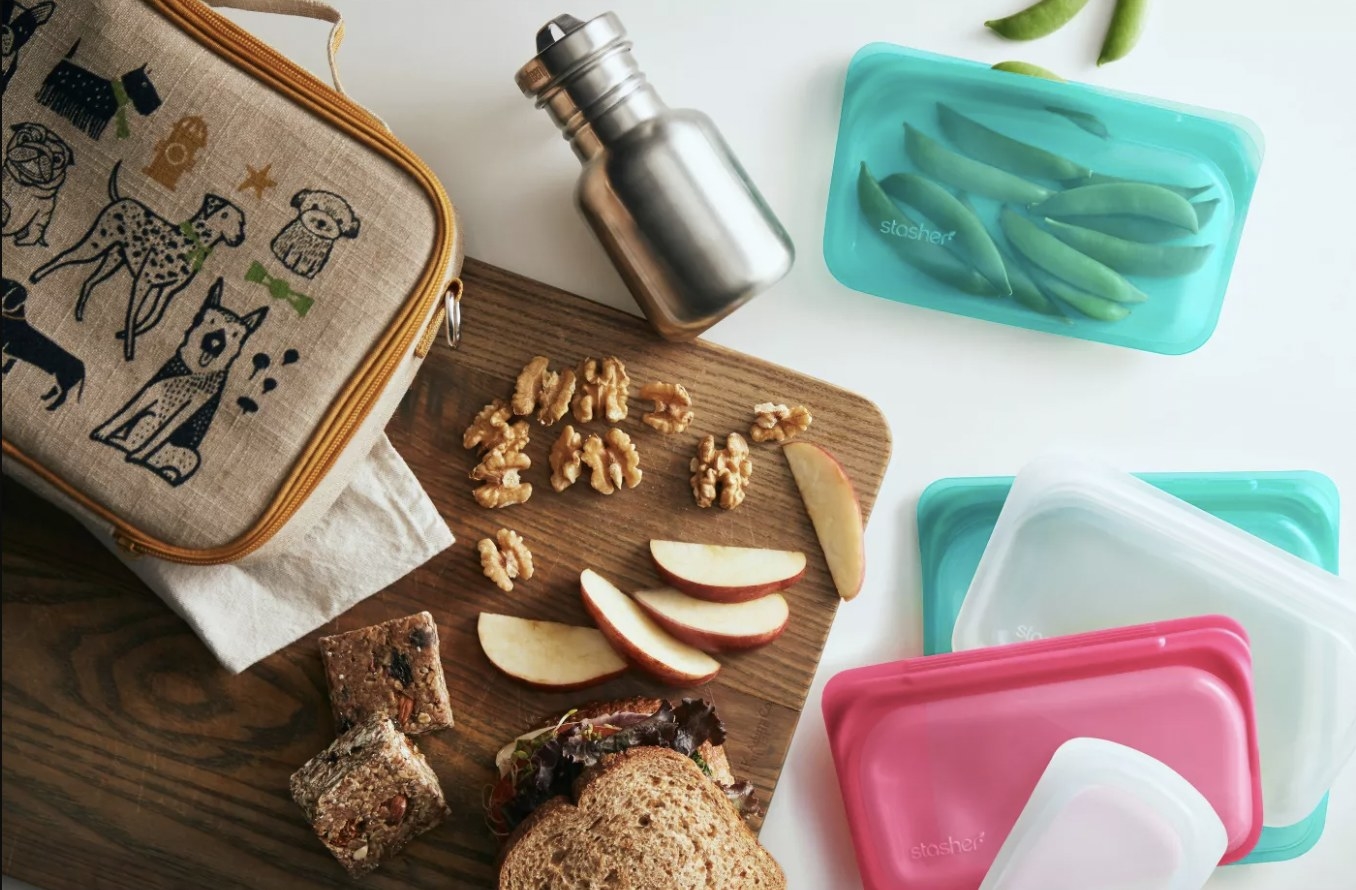 Snacks on a cutting board with Stasher bags