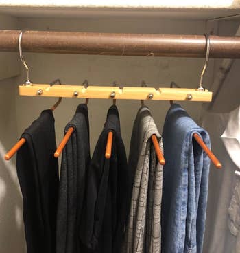five pairs of a reviewers pants on the hanger