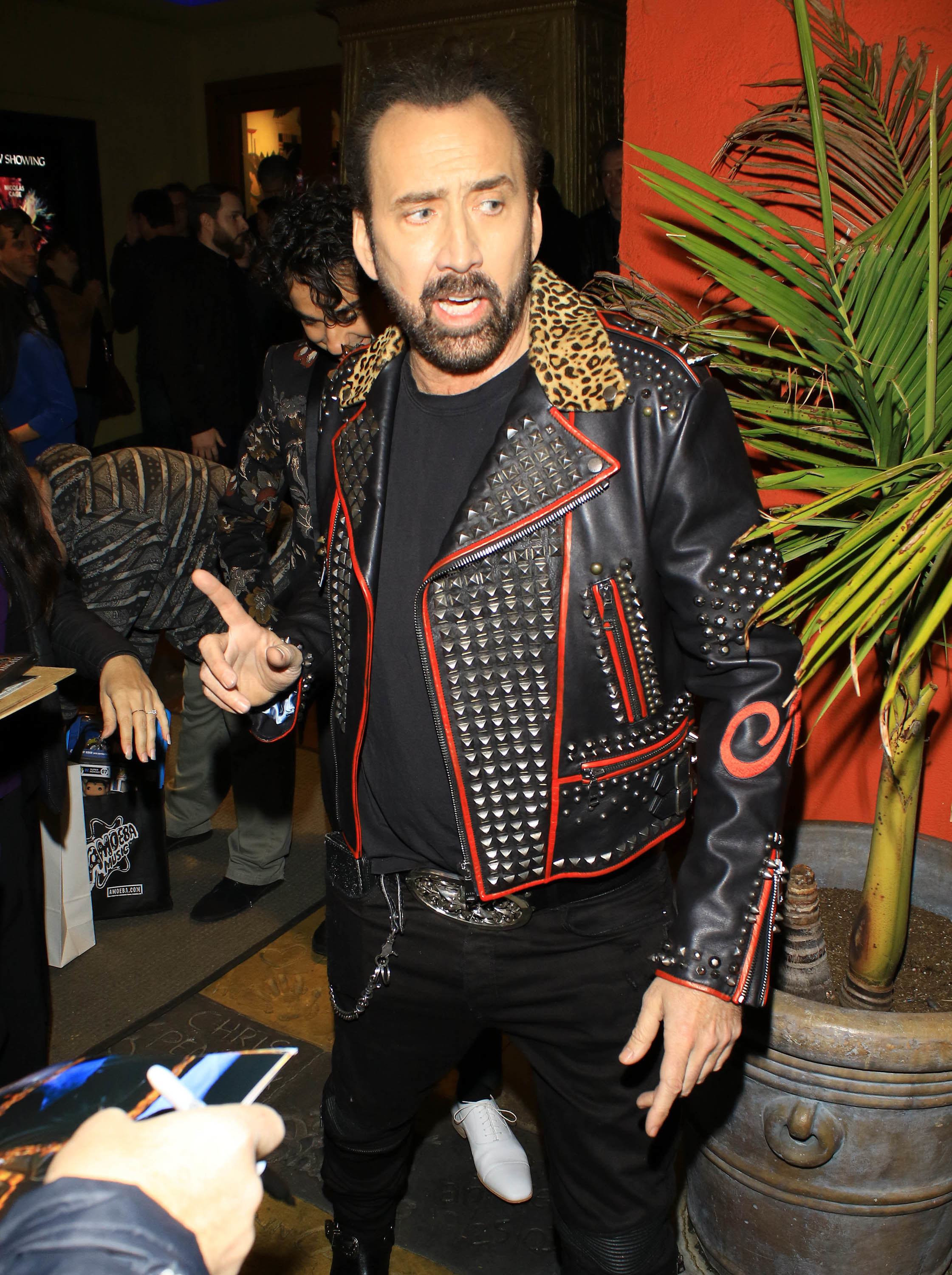 Cage wears a studded jacket