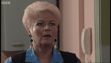 Pat Butcher is in shock while Frank stands naked with only a bow-tie