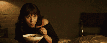 Scarlett Johansson as Molly looking incredibly satisfied with the bowl of pasta that she is eating