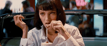 Uma Thurman as Mia Wallace closing her eyes as she takes the first sip of milkshake