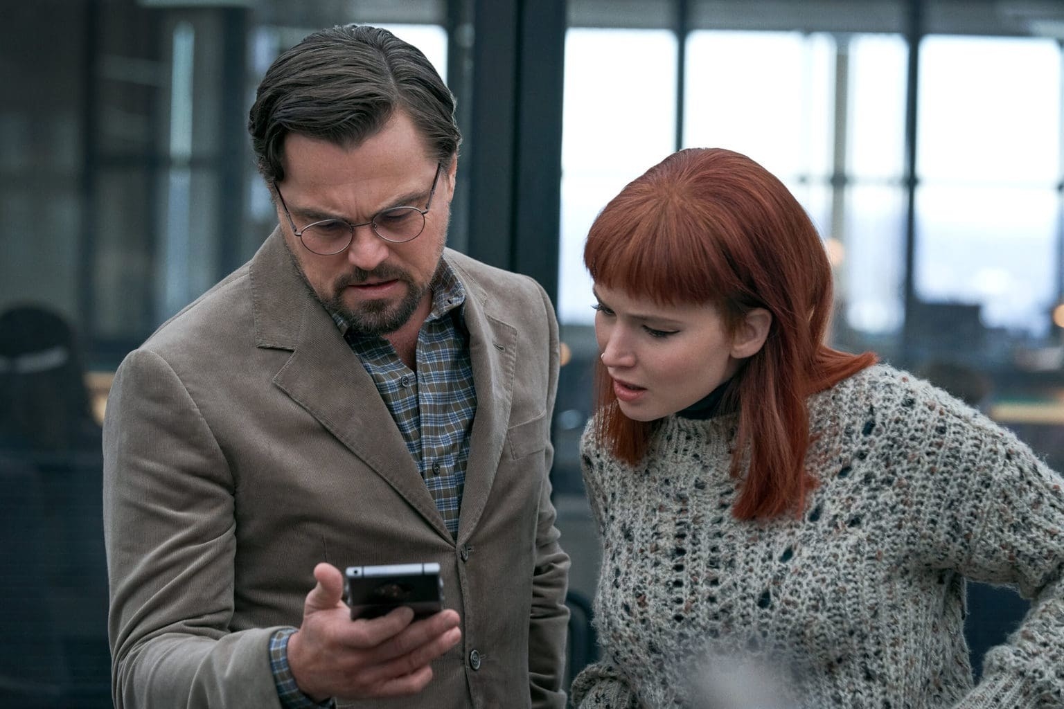 Randall and Kate looking at their phones
