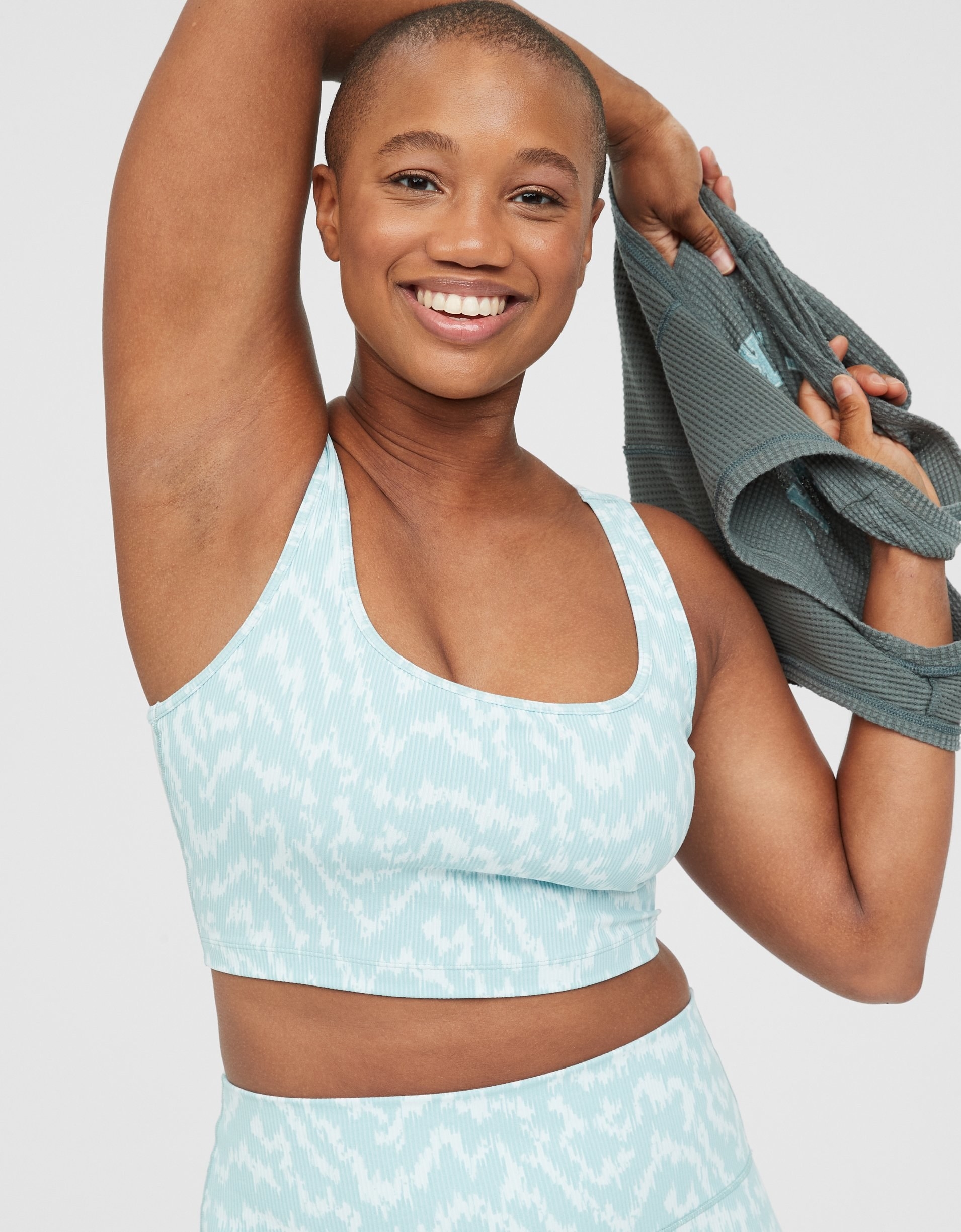 model in light blue and white patterned round-neck sports bra