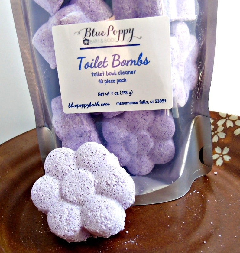 purple flower-shaped fizzy toilet bombs on table
