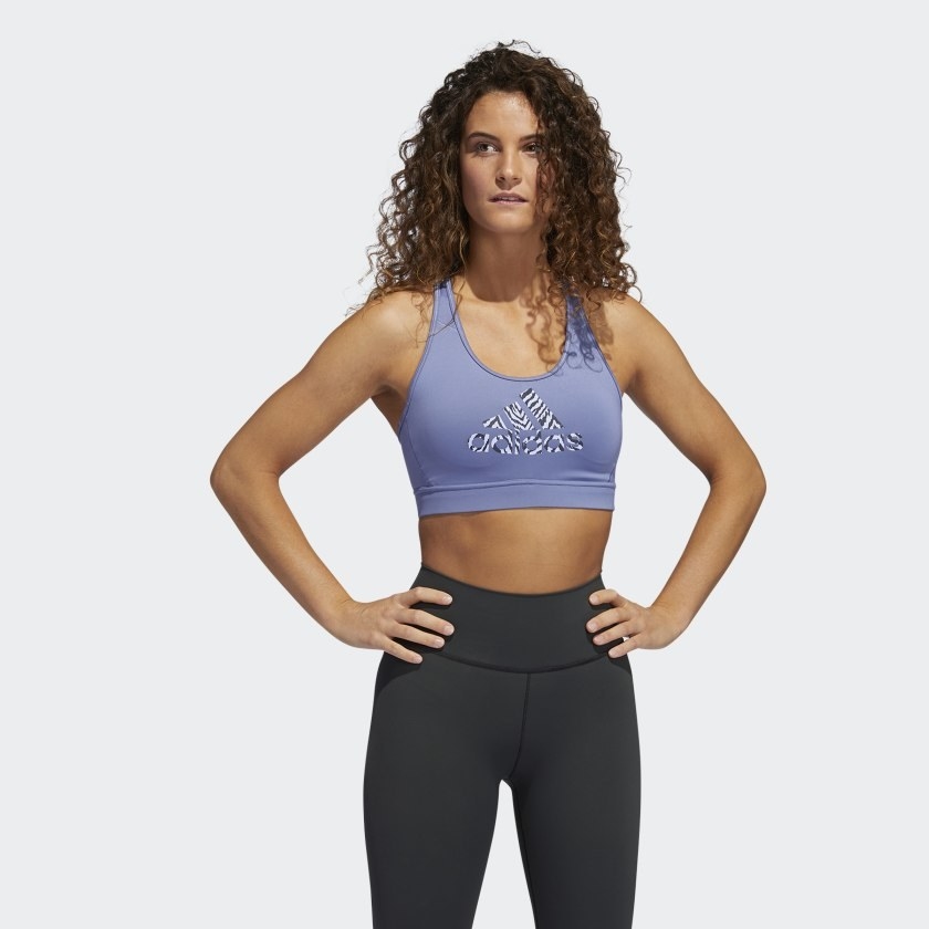 An image of a model wearing a medium-support sports bra