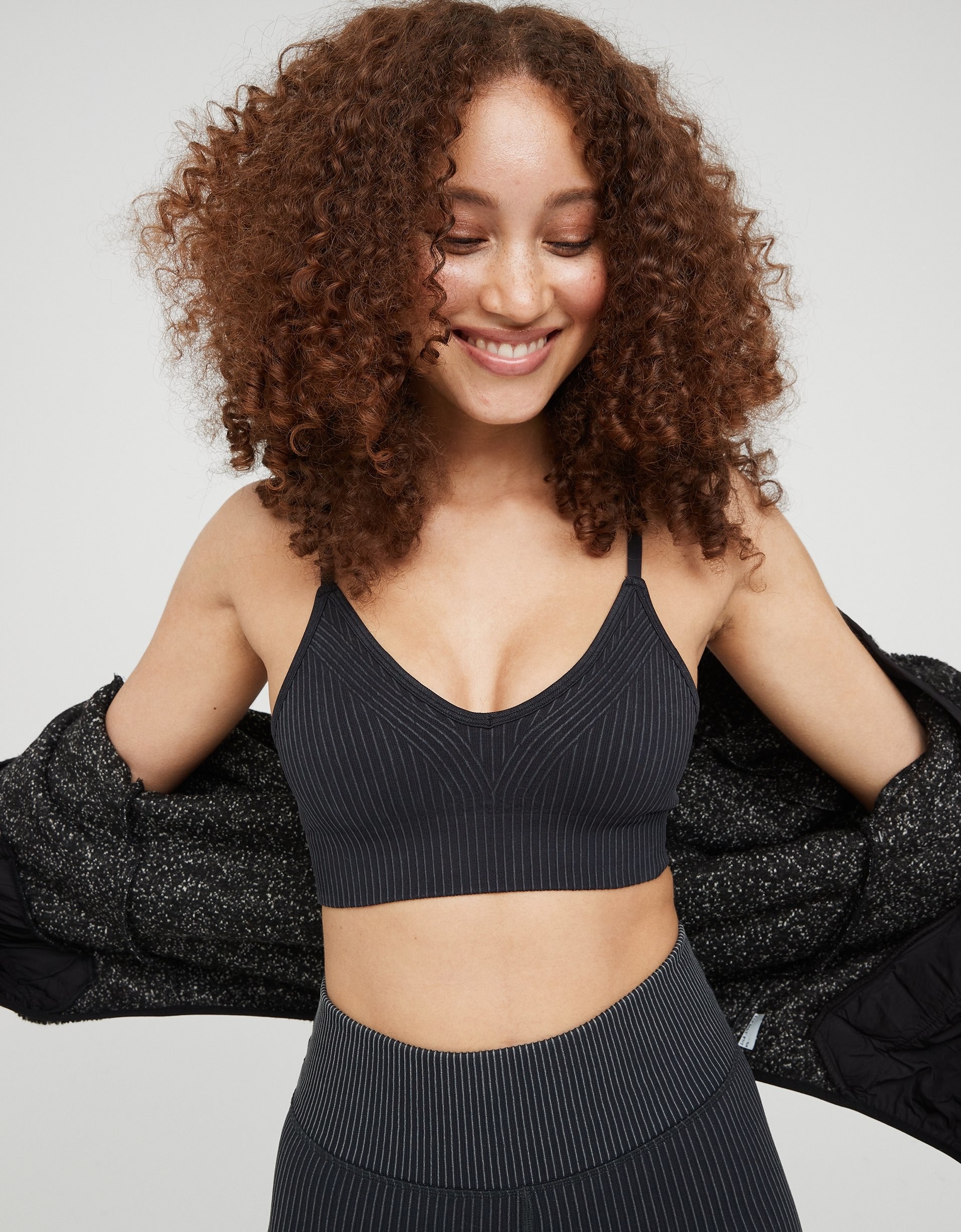 model wearing the thin-strapped sports bra in black