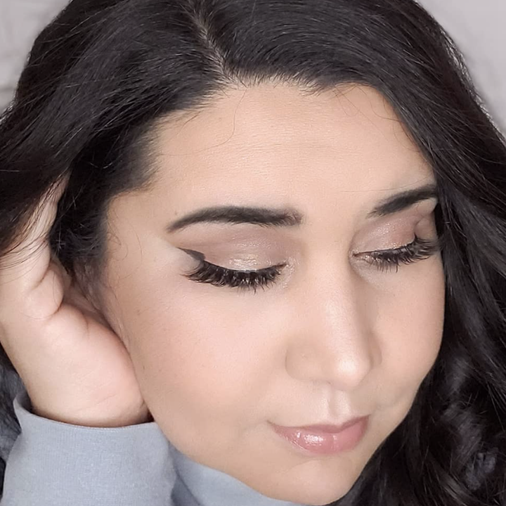 reviewer wearing eyelashes that were applied with glue