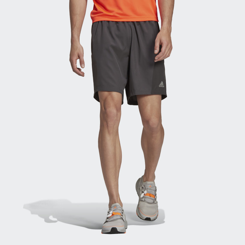 An image of a model wearing a pair of grey running shorts