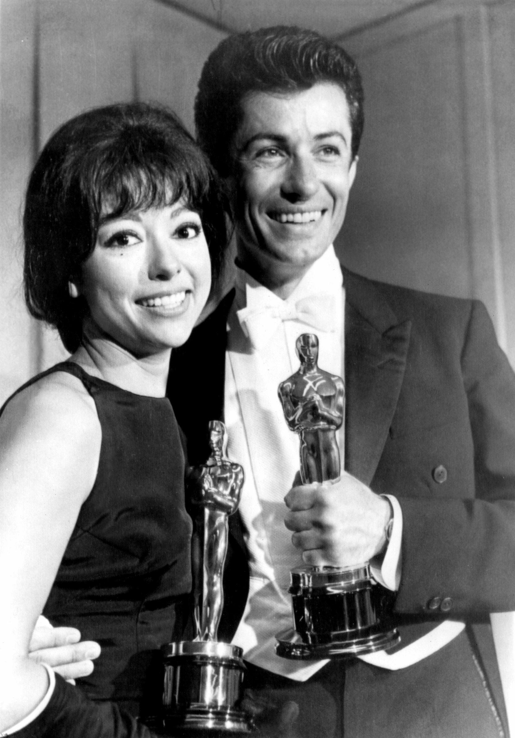 Moreno holding her Oscar with her co-star