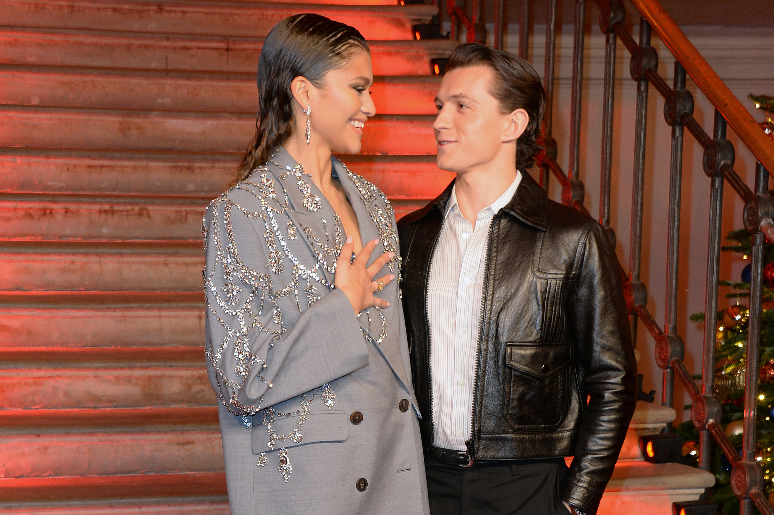 Zendaya and Tom Holland looking at each other an event for Spider-Man: No Way Home