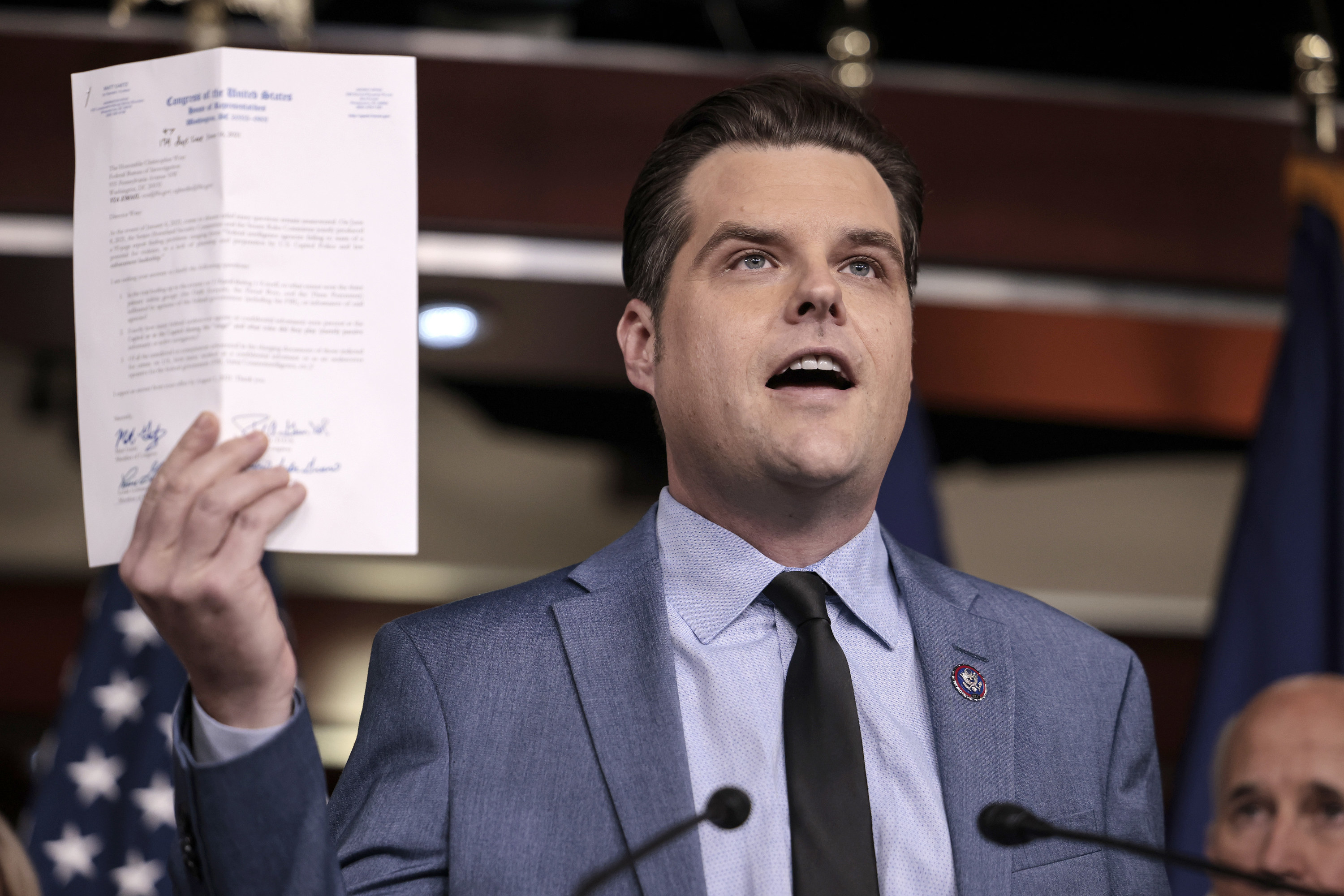 Matt Gaetz holding up a paper in a press conference while talking about the mistreatment of insurrection defendants in jail