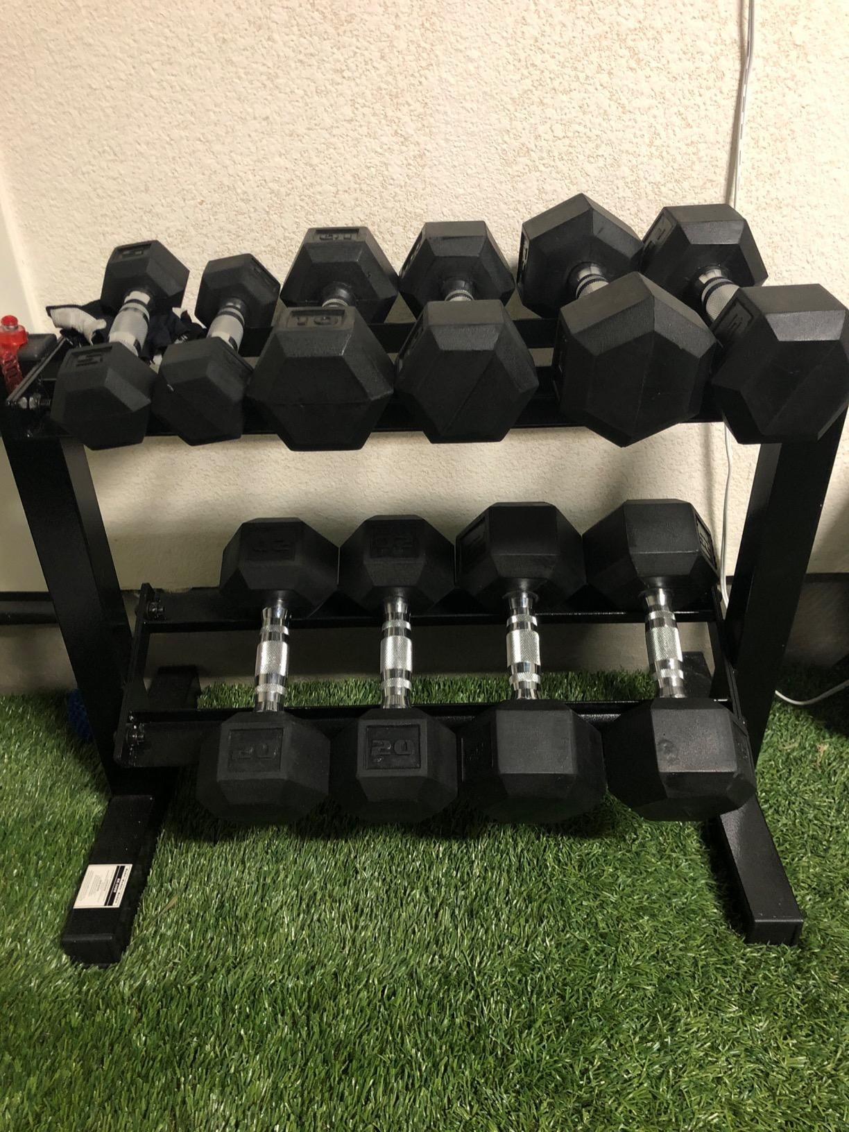 Reviewer photo of the dumbbell set on top of the rack