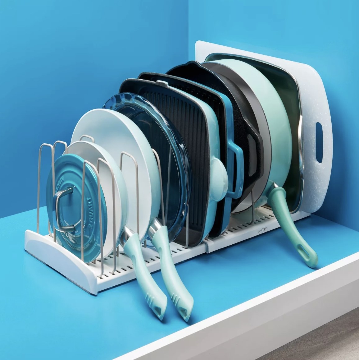 the rack holding pots and pans in an organized way