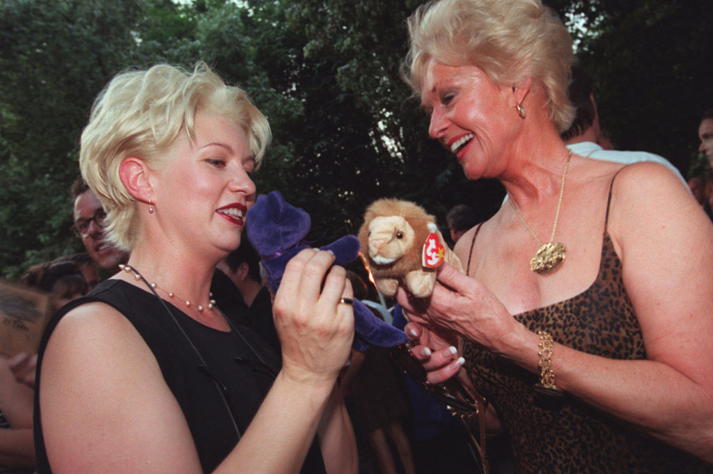 Two friends laugh with a bear and lion Beanies