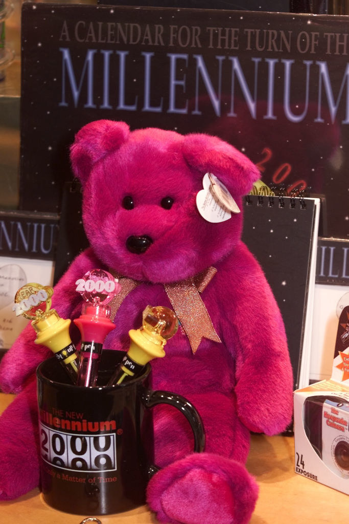 A purple bear straddling and 2000 mug