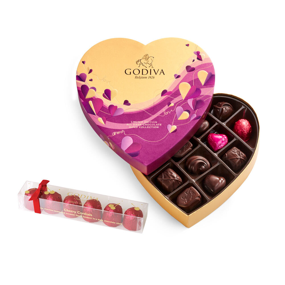 a heart-shaped box filled with dark chocolates