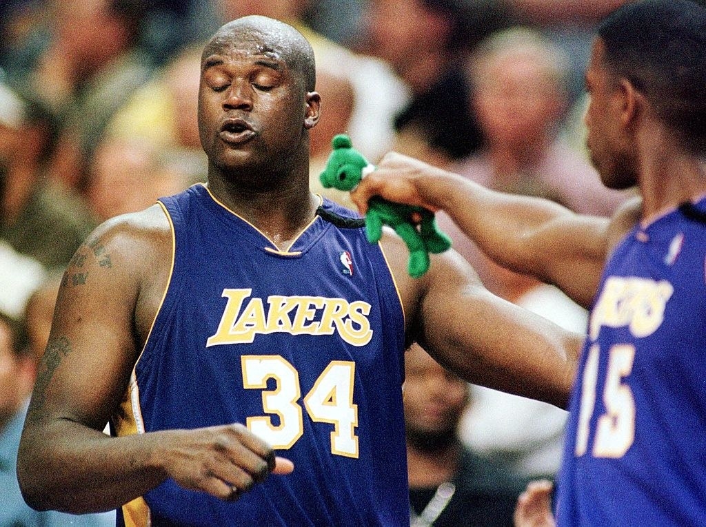 Shaq is given a green Beanie Baby on the basketball court