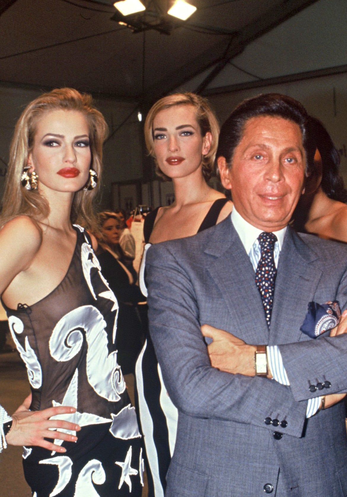 Linda wearing the dress and posing for a photo with the designer Valentino Garavani