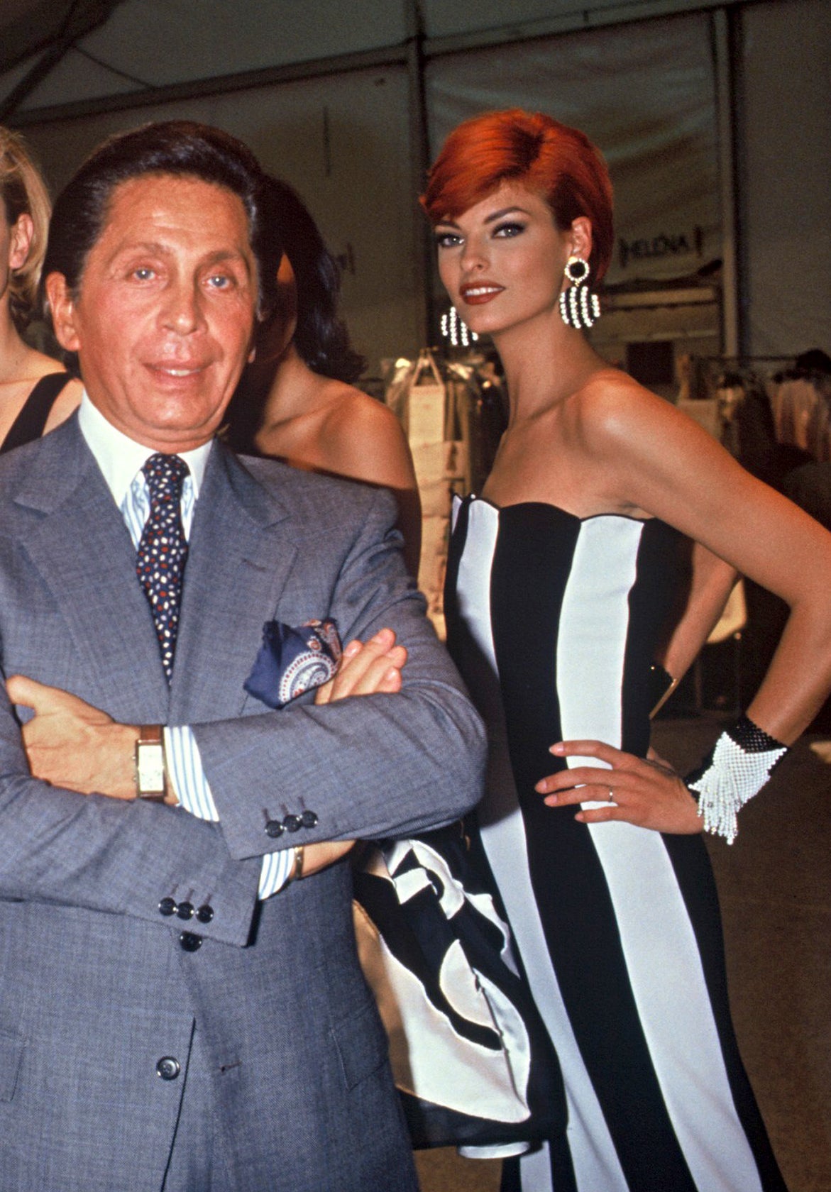Linda wearing the dress and posing for a photo with the designer Valentino Garavani