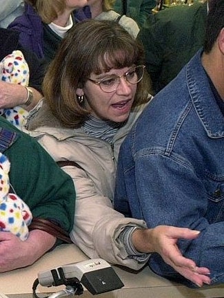 A close-up of a woman grabbing at a cashier