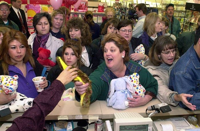 A cashier hands a snake to a very excited woman