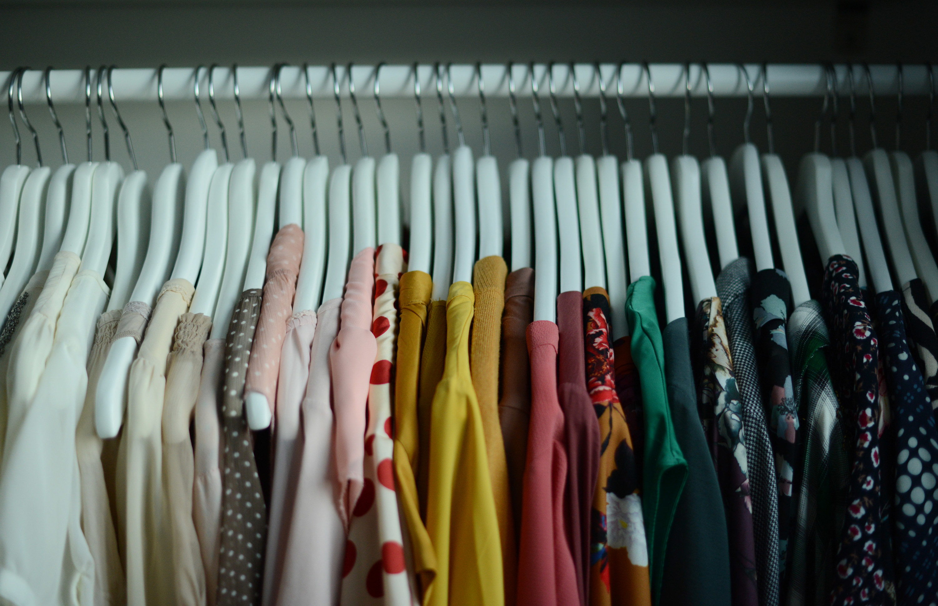 A closet showing clothes on hangers
