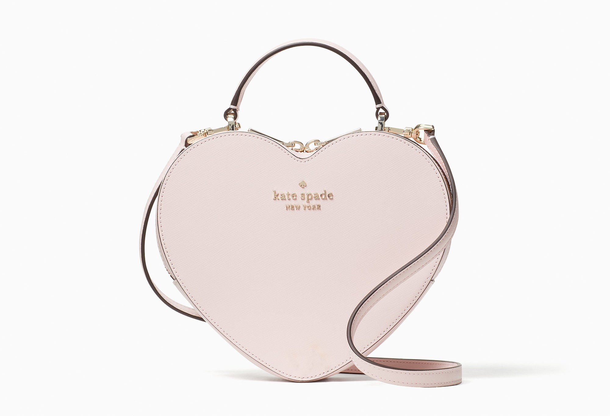 a light pink heart-shaped kate spade bag
