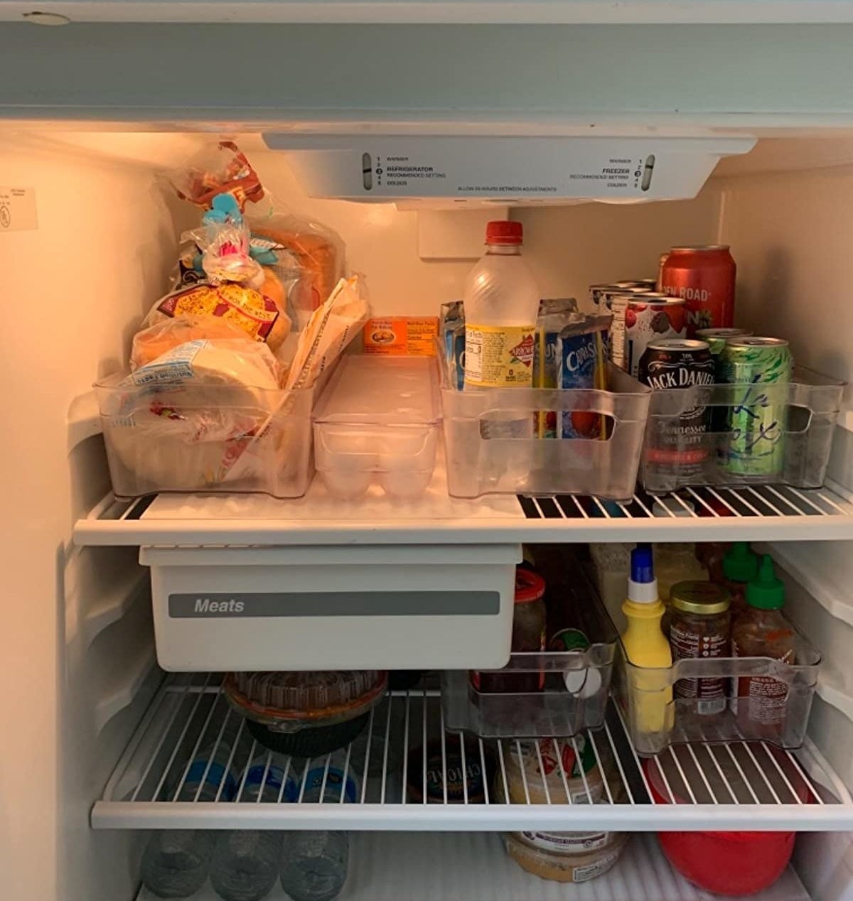 a reviewer photo of an open fridge organized with the clean bins
