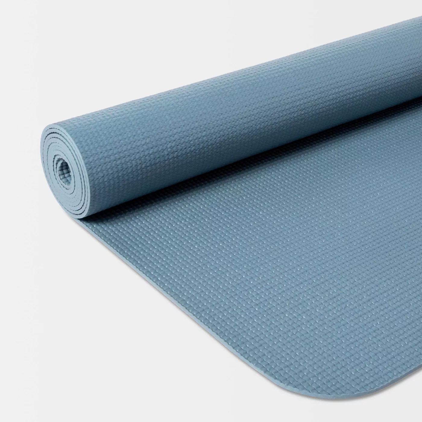 A blue yoga mat partially unrolled