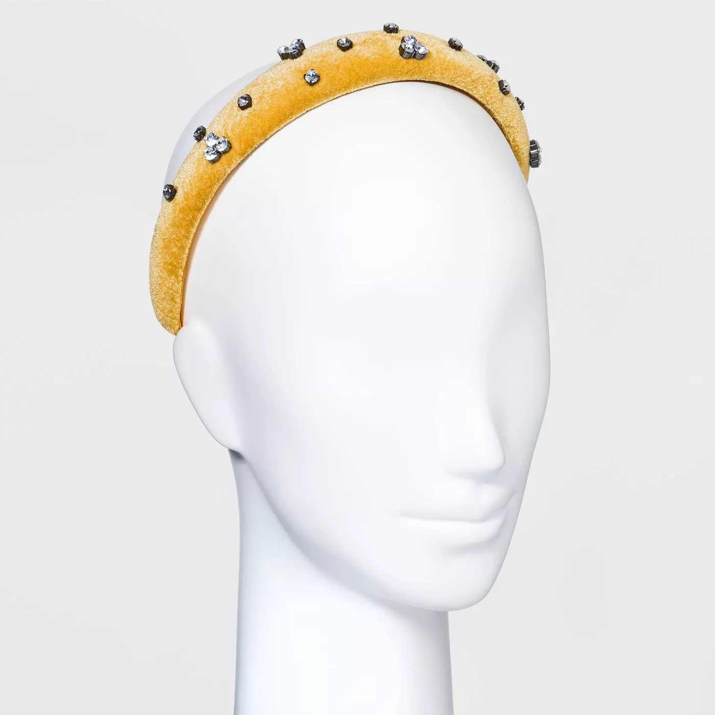A yellow puffy velvet headband with crystals