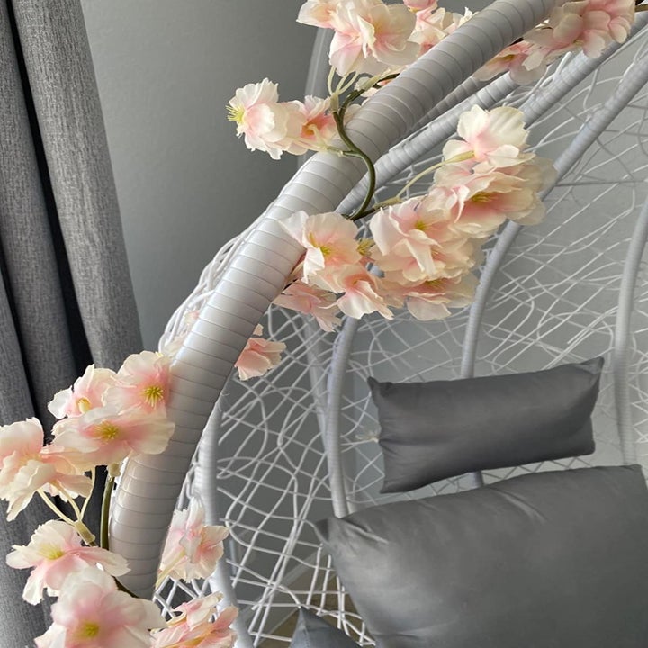 swinging chair with flowers around the edge