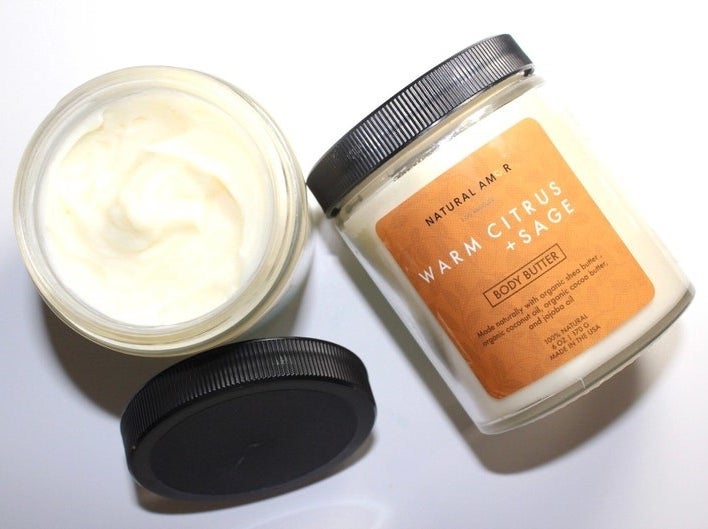 an open jar of body butter showing the creamy consistency next to a closed jar