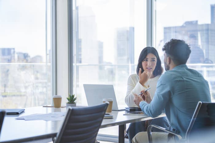 Business people having a casual chat in a conference room