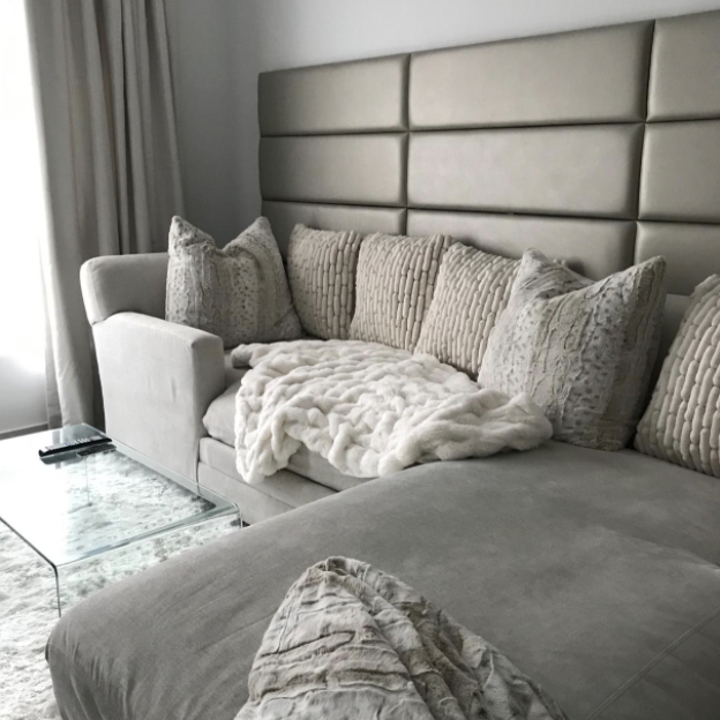 wall panels on living room wall in color that matches the sofa