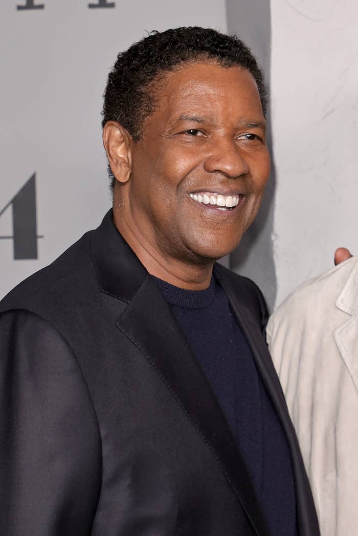 Denzel smiles at an event