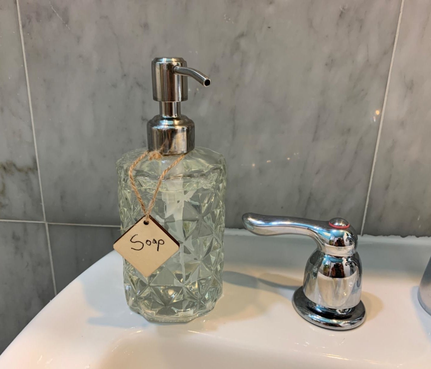reviewer image of the geometric dispenser on the corner of a bathroom sink