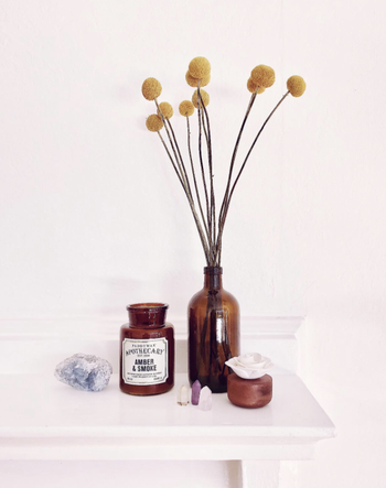 reviewer's candle beside matching amber bottle