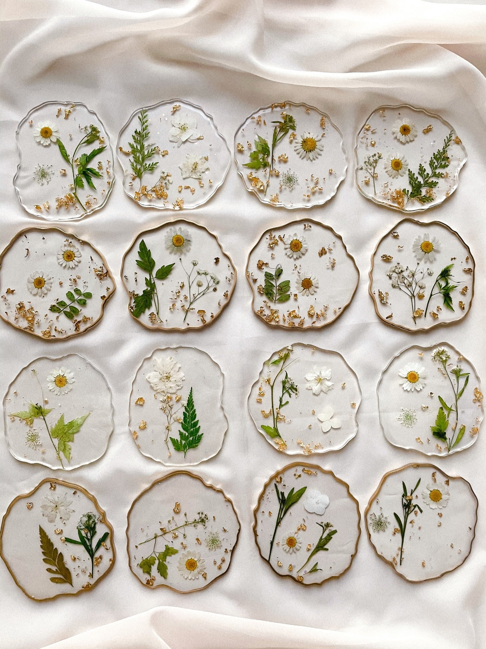 A variety of the floral resin coasters laid out