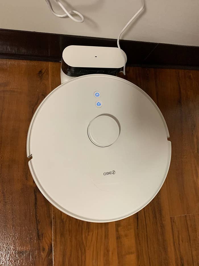 reviewer image of the robot vacuum in its charging port