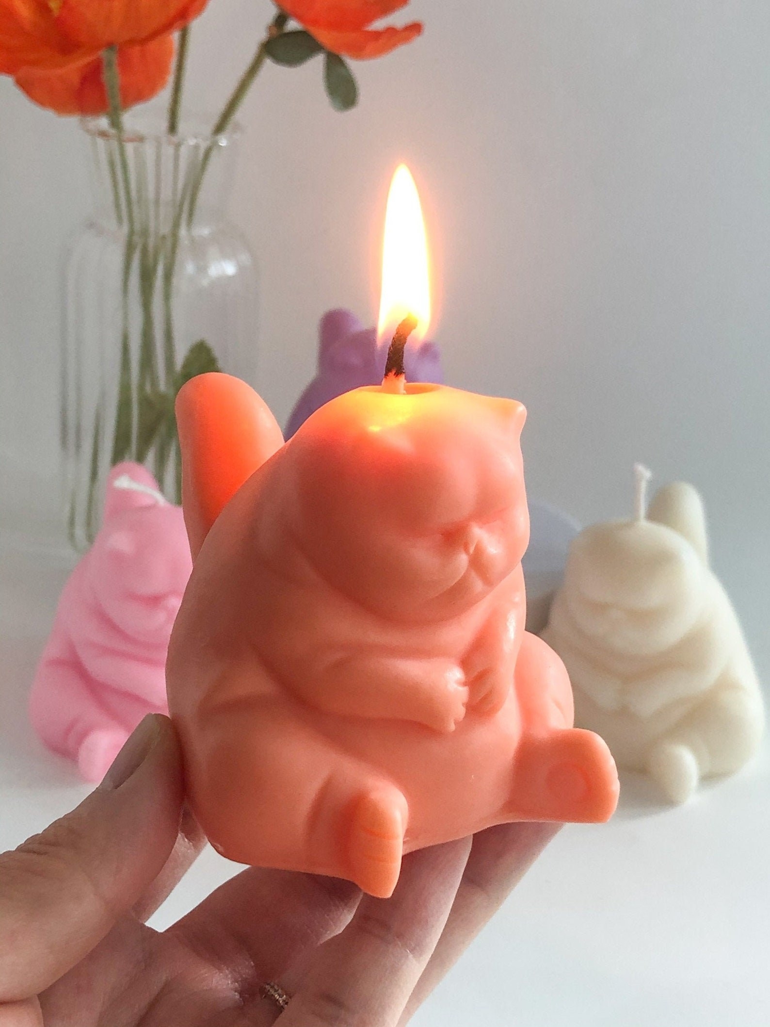 A person holding the candle in orange
