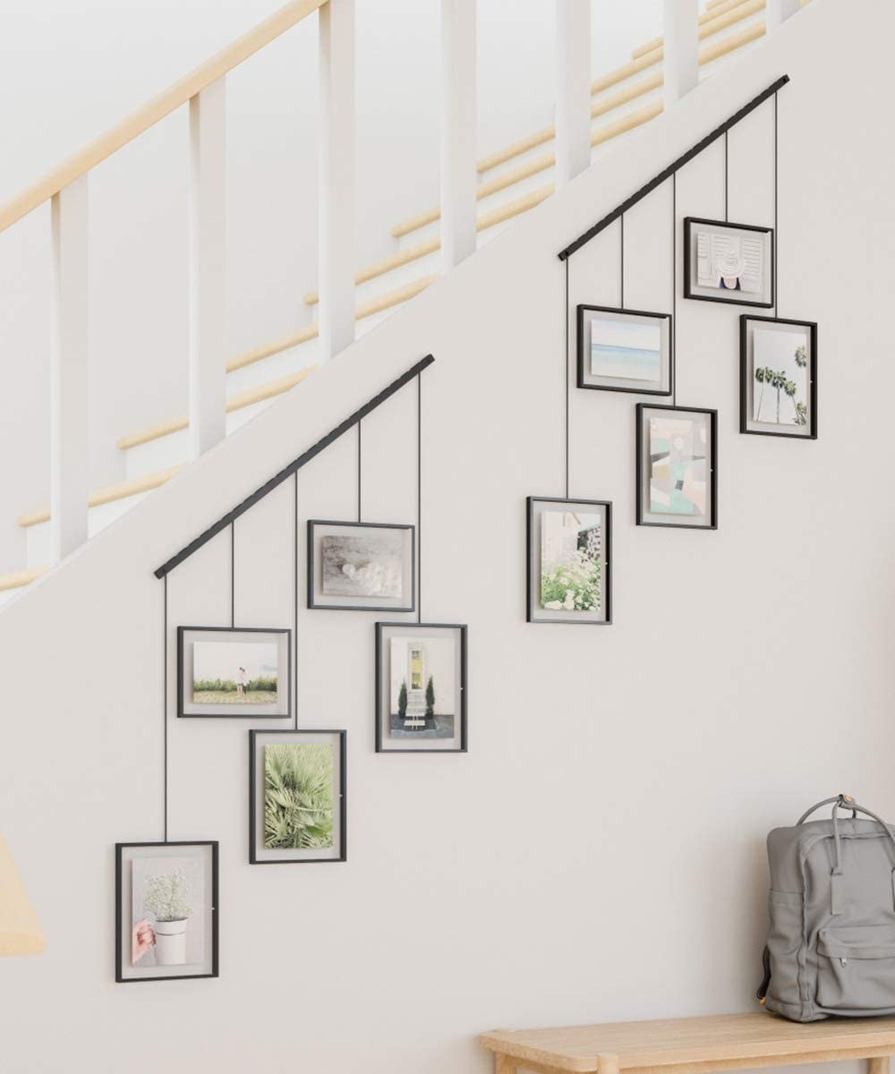 a pair of angled hanging frames mounted on a stair wall