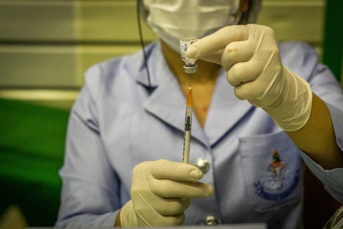 A health worker prepares a booster vaccine.