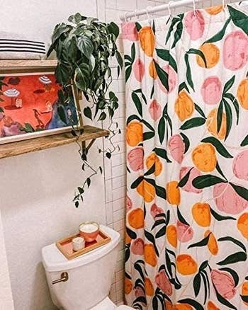 shower curtain in white tile bathroom with plants all around