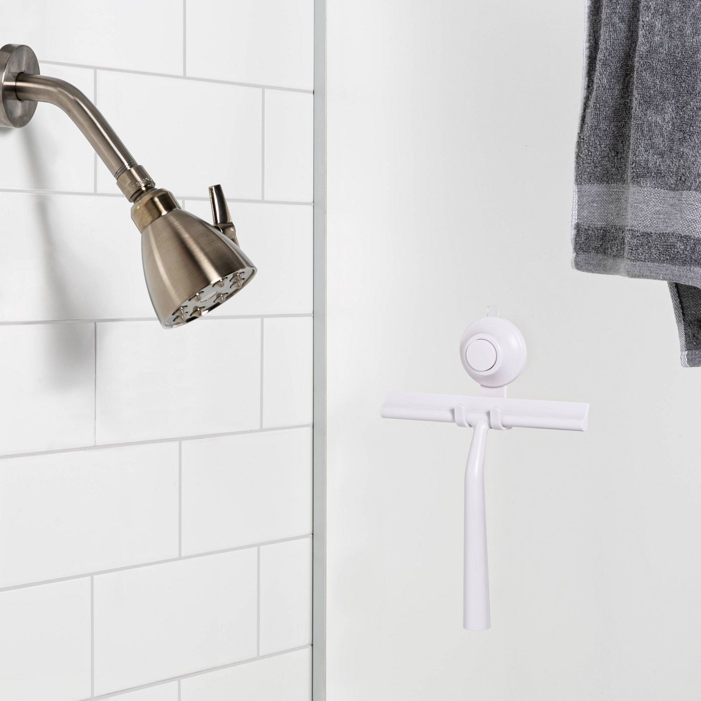 the white squeegee hanging in a shower