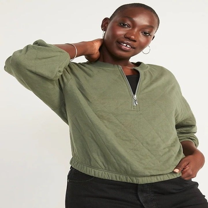 model wearing the olive green sweatshirt