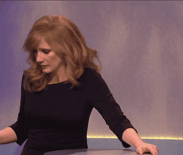 jessica chastain yanking a cork out of a bottle of wine